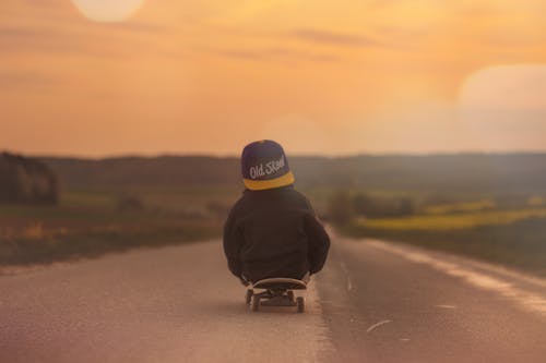 Child in Black Jacket Blue Yellow Old School Print Fitted Cap Riding Skatebaord