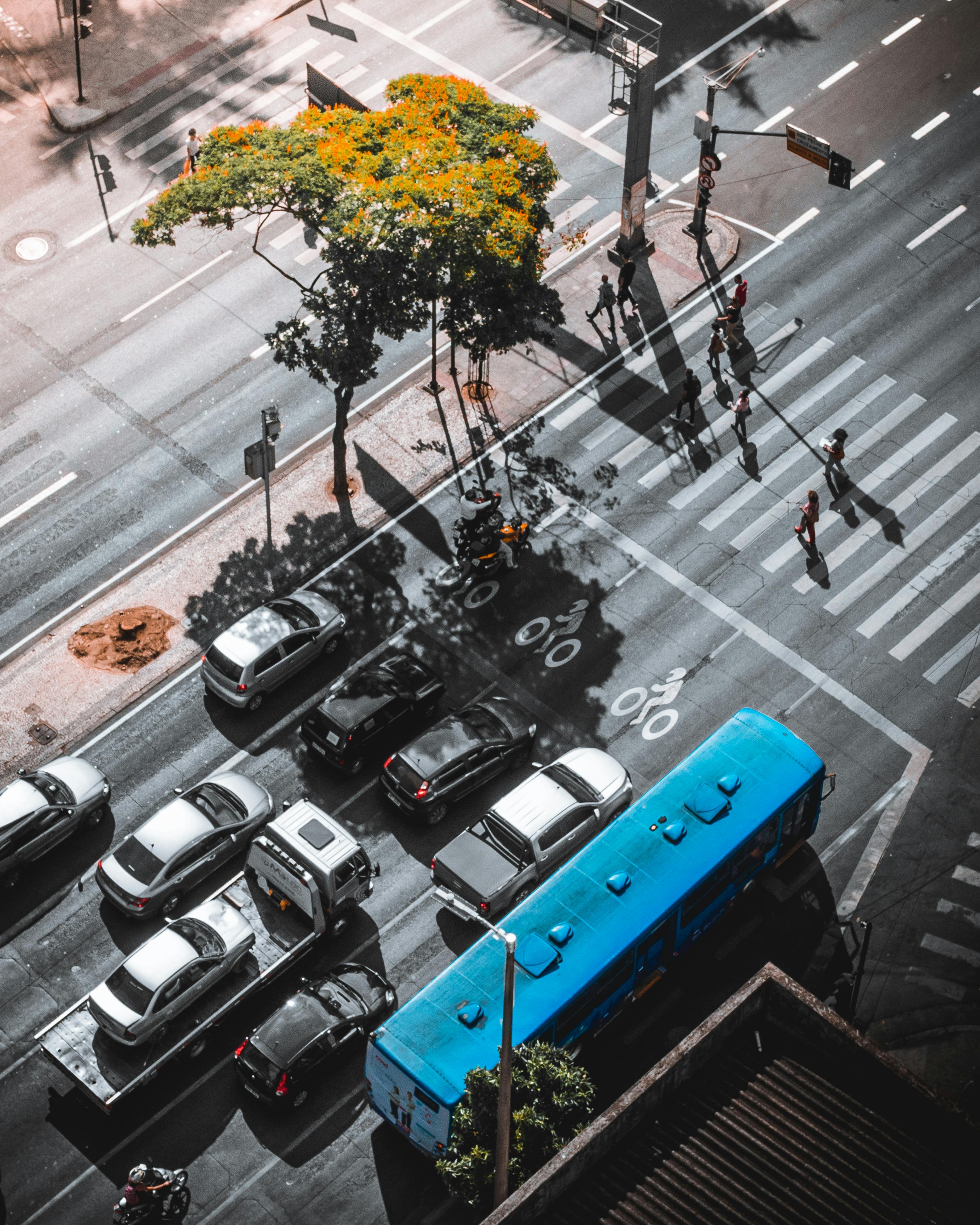 Aerial perspective of a busy street crossing in Belo Horizonte, showcasing vehicles and pedestrians.