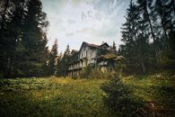 Brown Wooden House Surrounded by Green Trees Under White Clouds