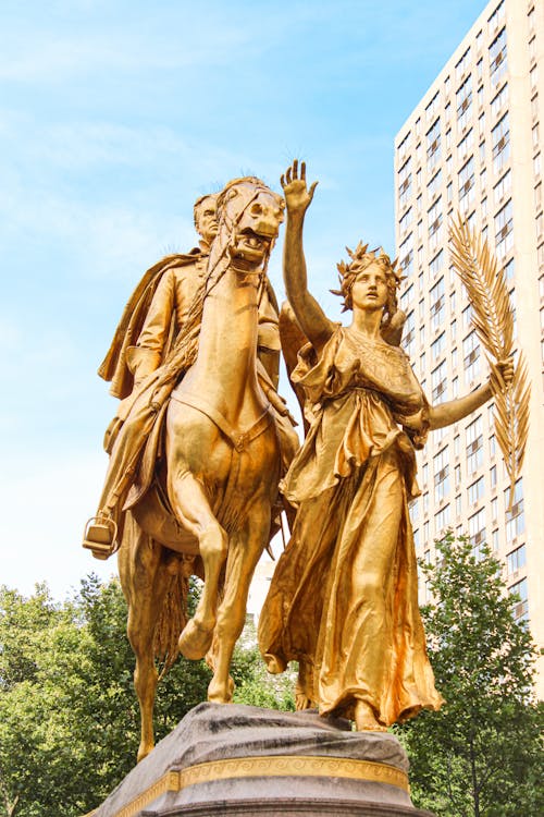 Free Gold Statue of Man and Woman Stock Photo