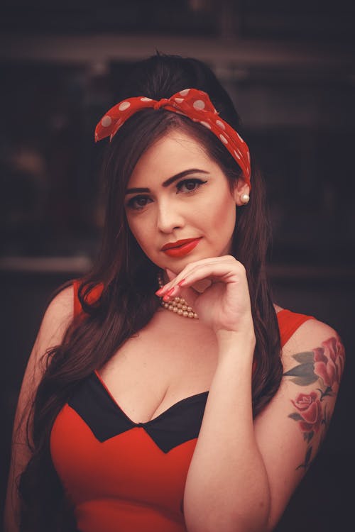 Woman in Black and Red Dress With Red and White Polka Dot Headdress