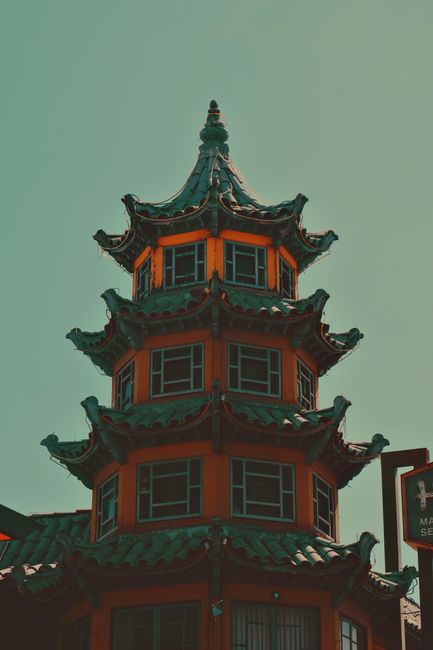 A multi-tiered pagoda with ornate roofs set against a vivid sky, showcasing architecture and culture.