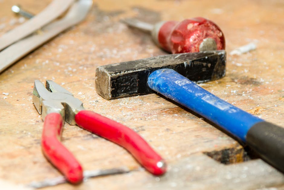 Red and Gray Pliers Beside Blue and Black Hammer