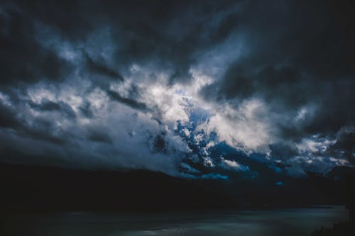 Free Dramatic clouds over river at night Stock Photo