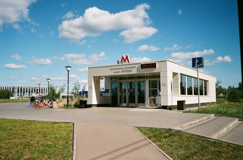Exterior of modern metro station on city street near sidewalk with grass at daylight