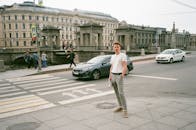 Man standing near pedestrian crossing on street