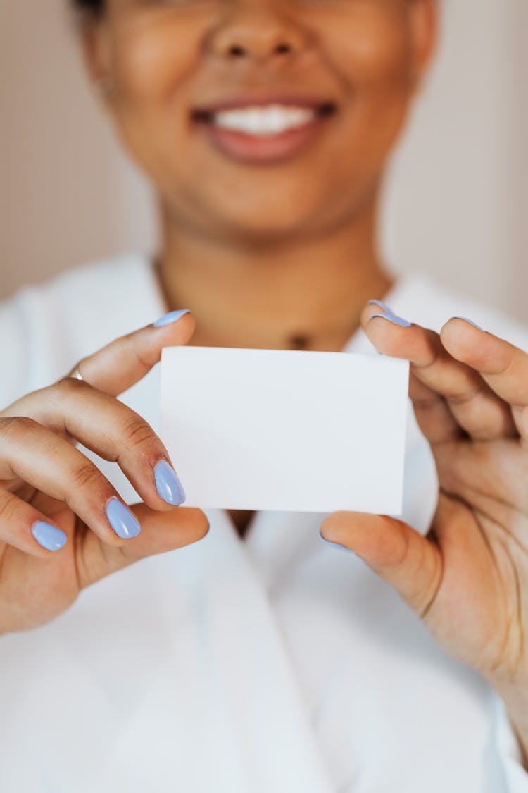 Person Holding A Small White Paper