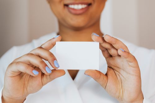 Free A person holding a blank card with both hands, offering ample copy space. Stock Photo