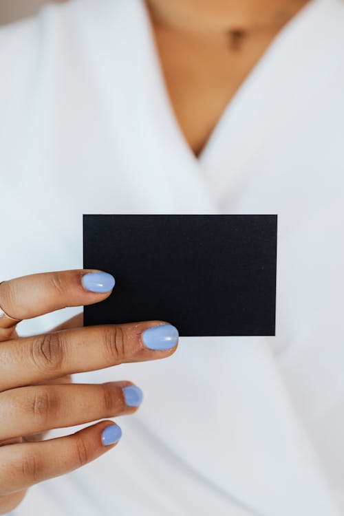 Person Holding a Small Black Paper