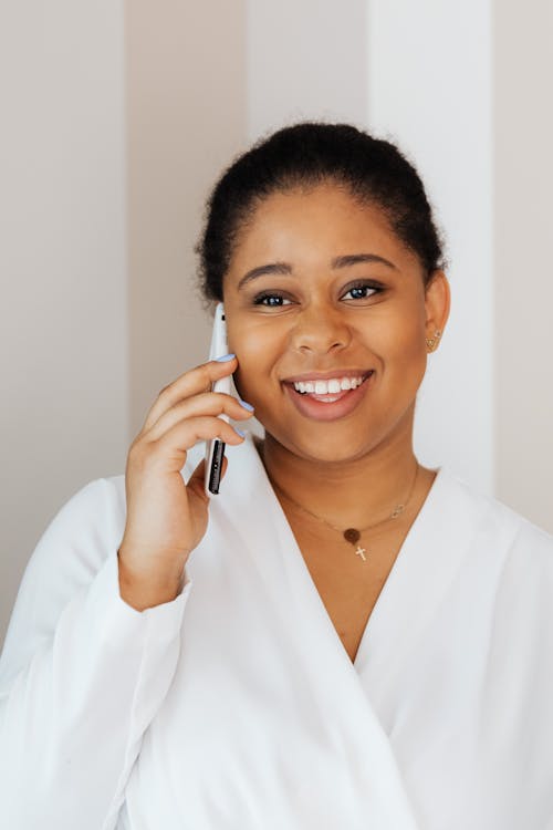 Free Woman in White Top Talking on Cellphone Stock Photo