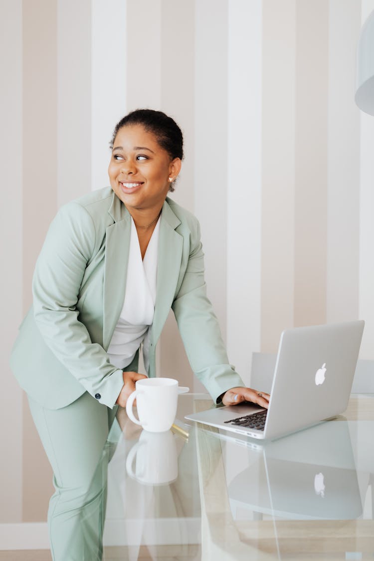 Woman In Light Green Suit Working In An Office