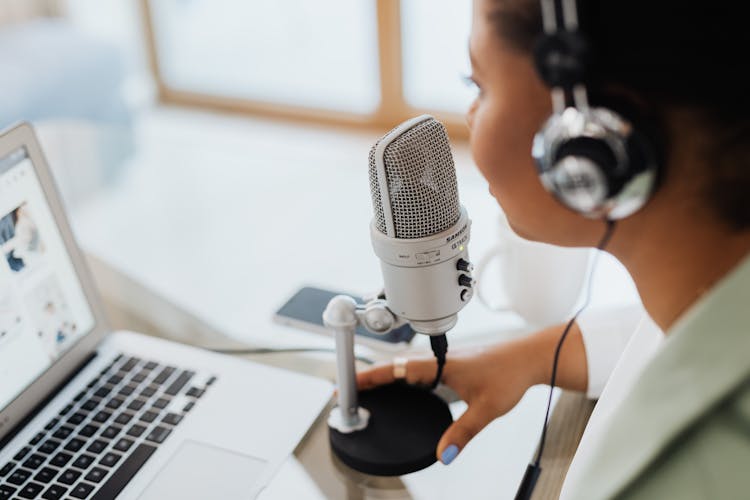 Woman With Headset Speaking Over A Condenser  Microphone