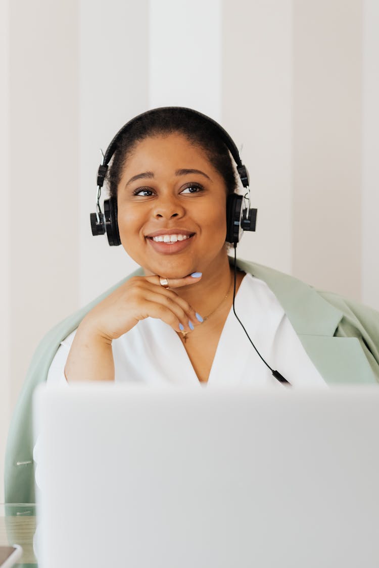 Smiling Woman Wearing Headphones And Using Laptop 