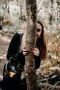 Woman Hiding behind Tree