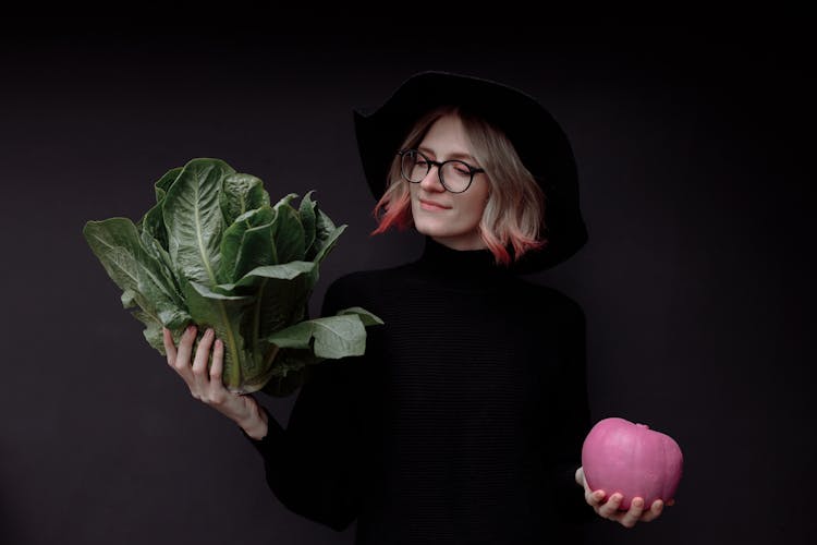 Woman In Black Turtleneck Long Sleeve Shirt Holding Pink Pumpkin And Green Lettuce