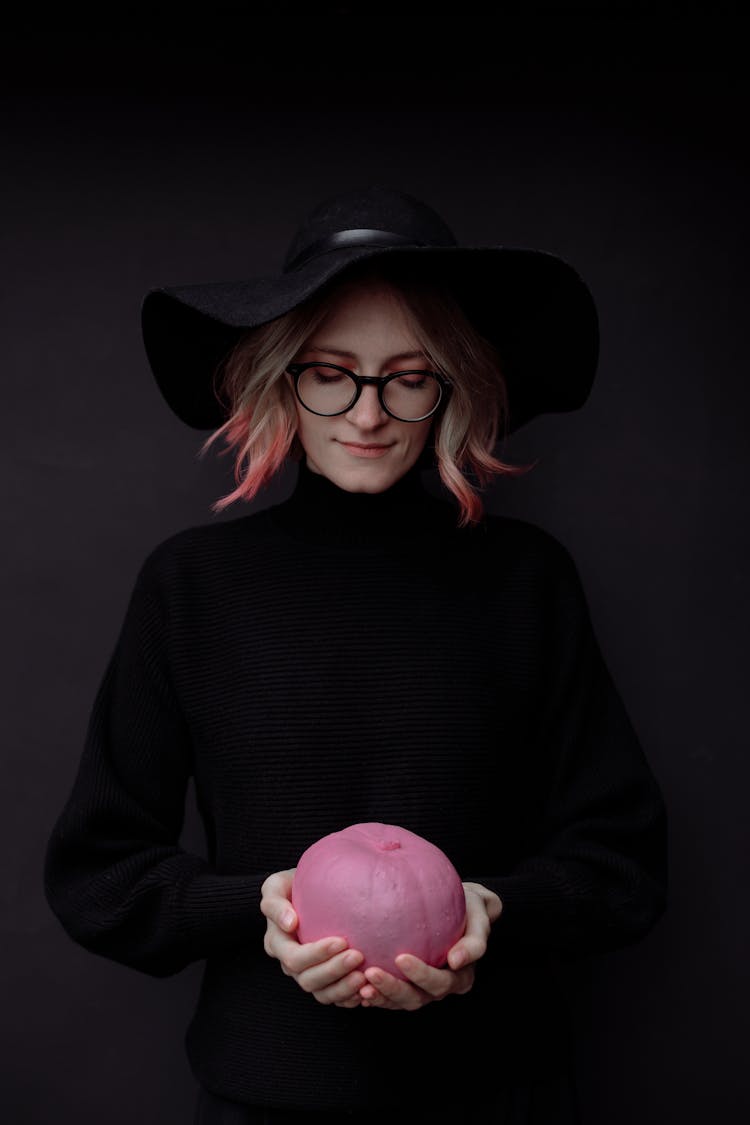 A Woman Looking At The Pink Pumpkin