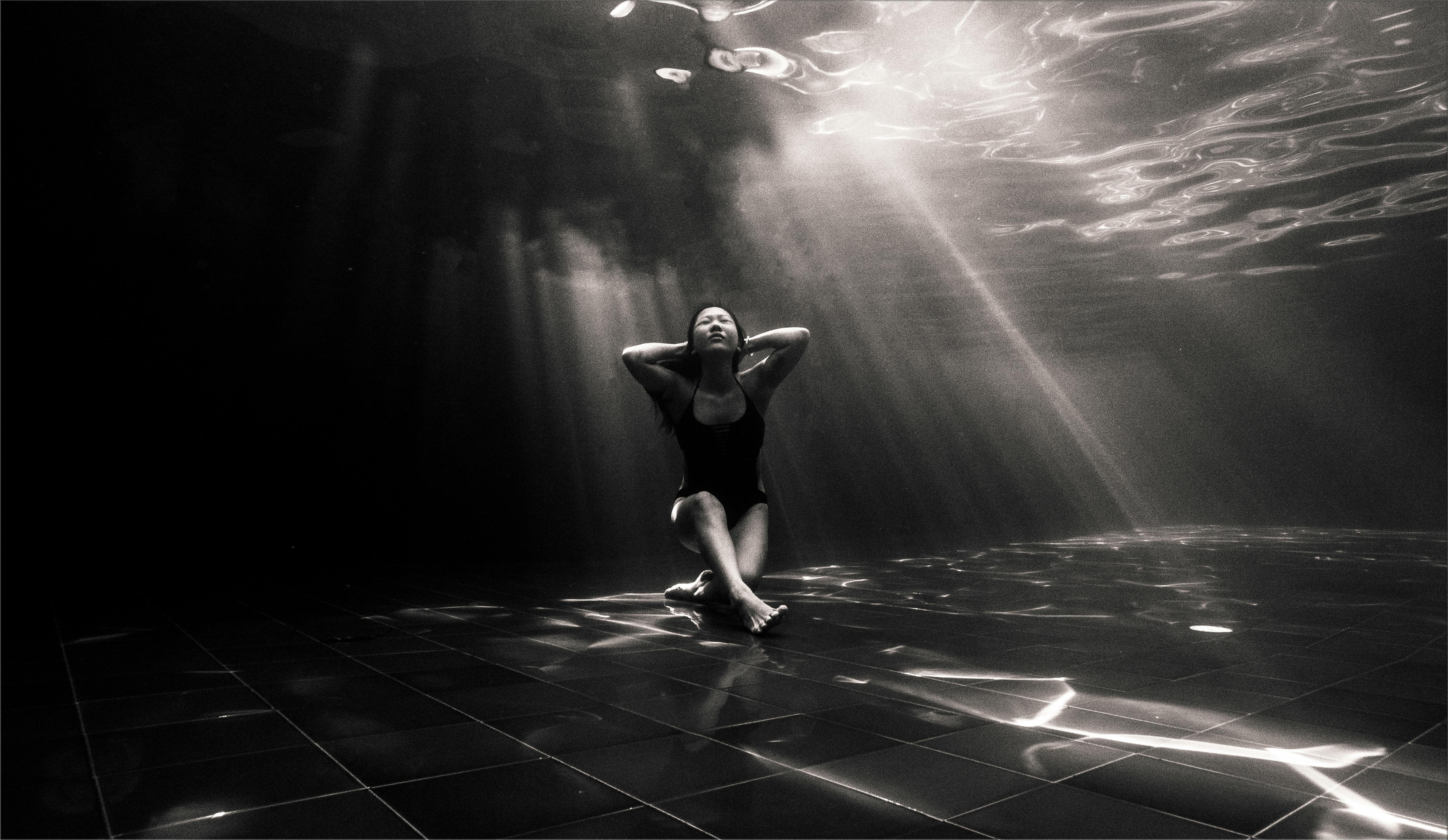 woman sitting underwater