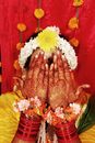 A Person Wearing Floral Headdress with Henna Tattoo on the Hands