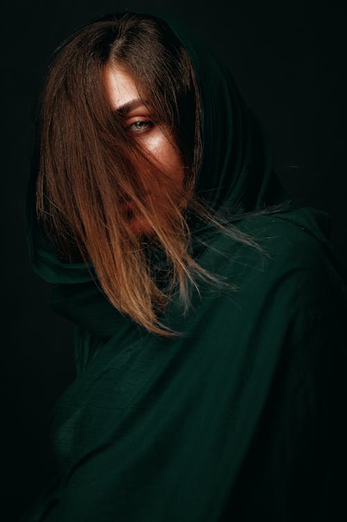 A Woman in Dark Green Headscarf