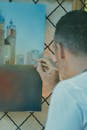 A Man in White Shirt Doing Painting