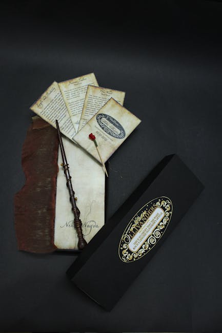 A Harry Potter wand with decorative box and letters on a dark background, showcasing wizarding elegance.