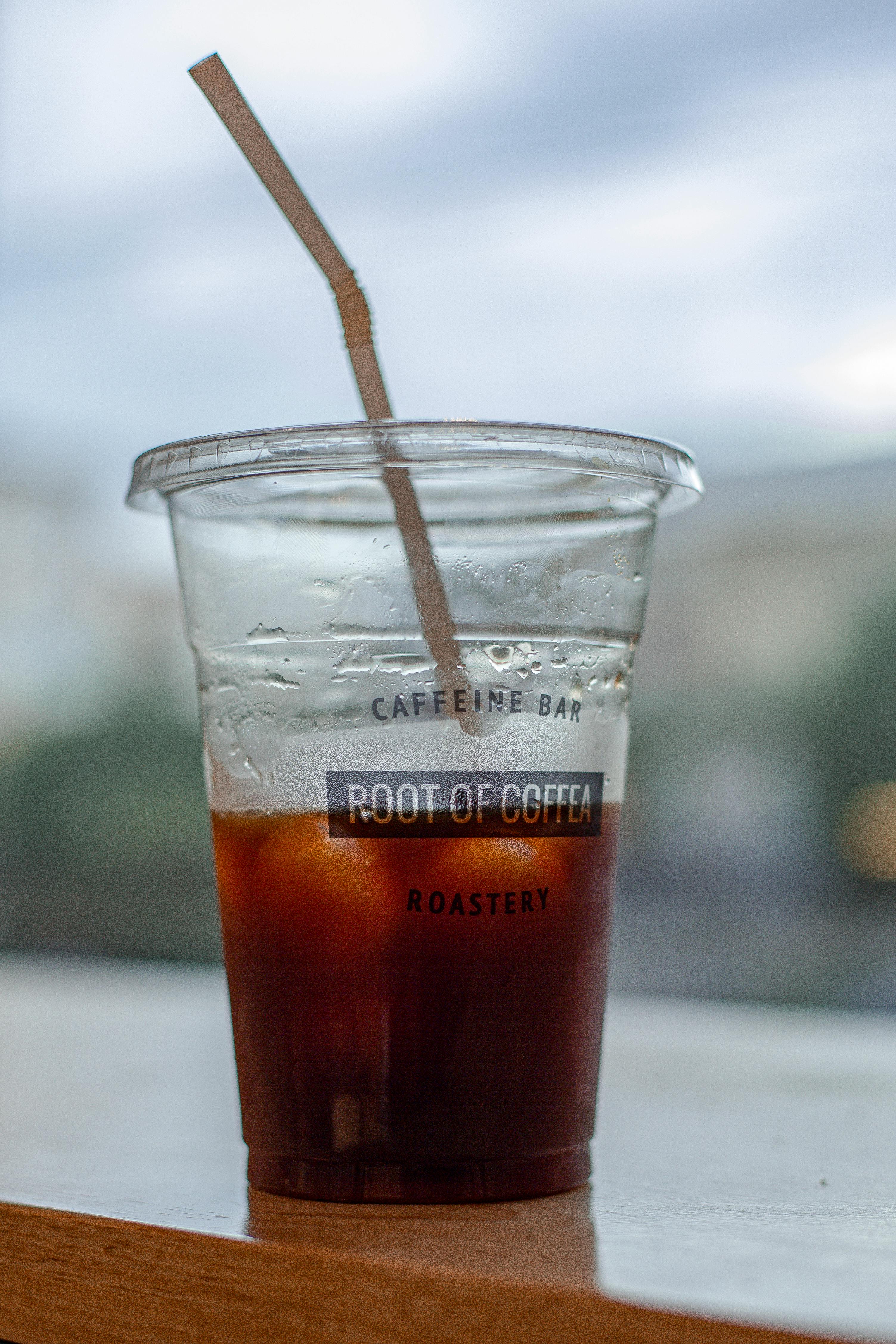 Plastic cup with iced tea on wooden table \u00b7 Free Stock Photo
