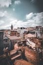 Brown and White Concrete Buildings Under White Clouds