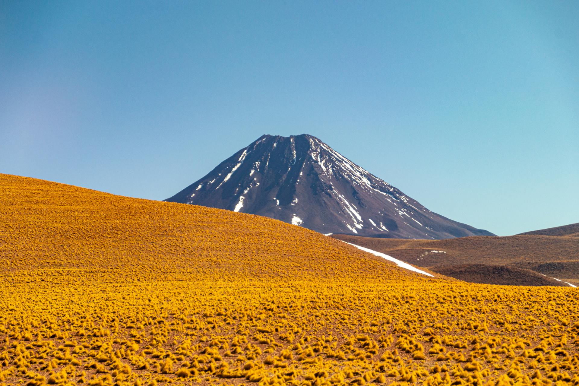 Stunning view of Licancabur Volcano against clear blue sky in San Pedro de Atacama, Chile.
