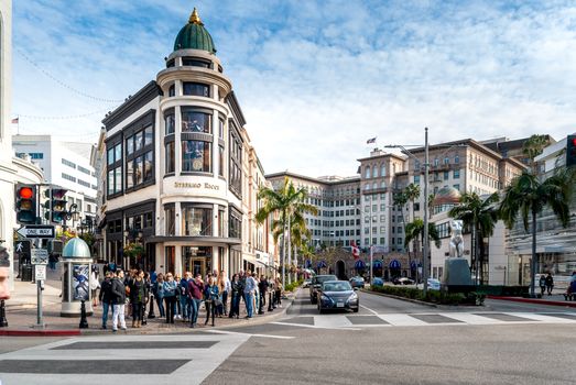 Street scene in Beverly Hills showing iconic buildings, busy pedestrian areas, and lively urban atmosphere.