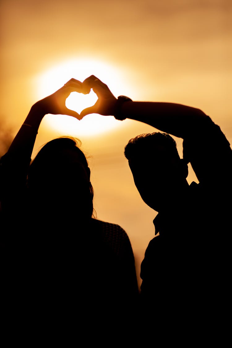 Silhouette Of Couple With Heart At Sunset