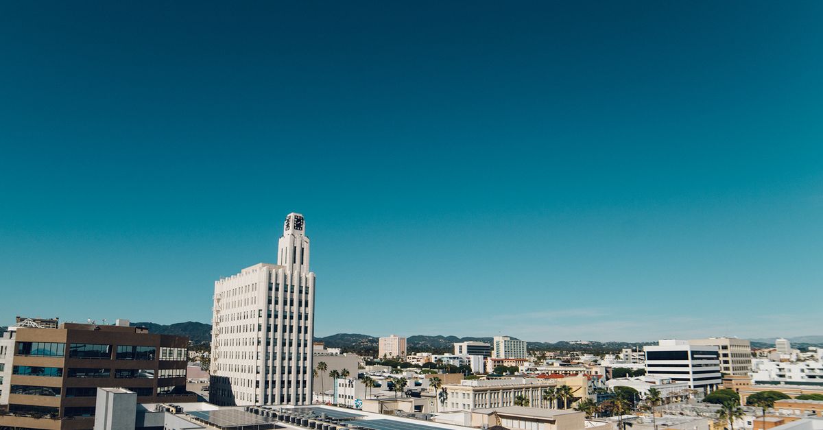 Aerial view of Santa Monica city skyline on a bright day with clear blue skies.