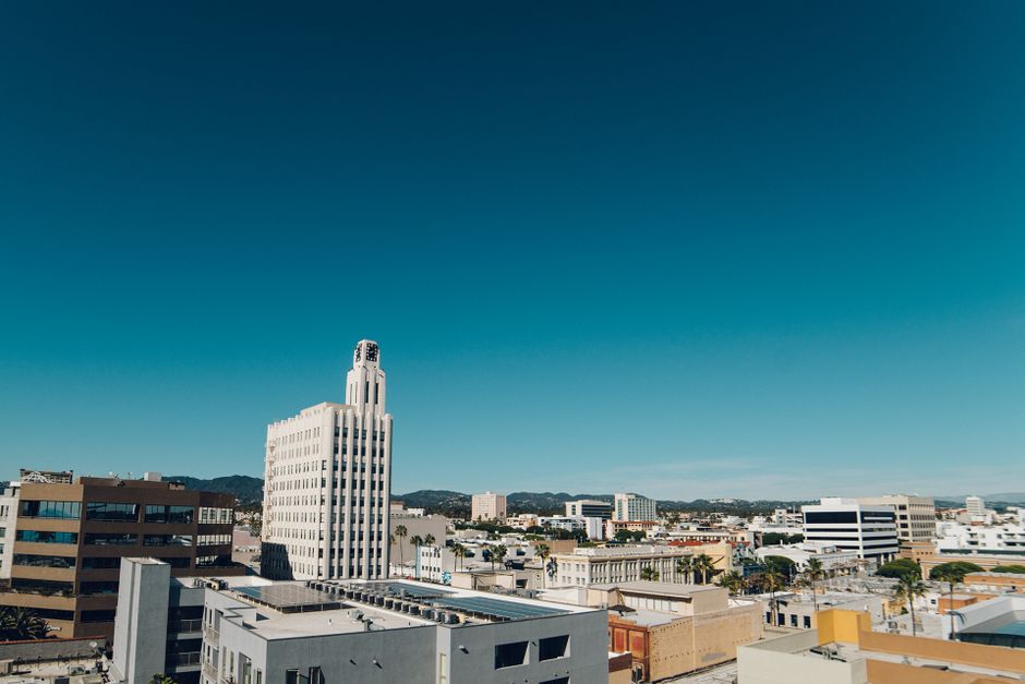 Aerial view of Santa Monica city skyline on a bright day with clear blue skies.