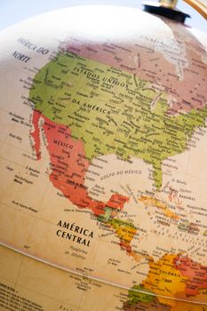 Close-up of a globe showing colorful countries in North America.