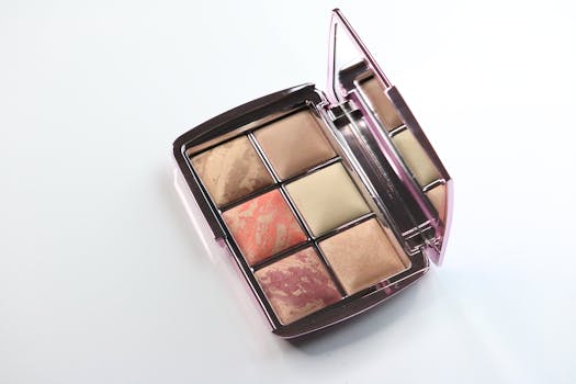An elegant makeup palette with various eyeshadows and mirror on a bright white background, perfect for beauty themes.