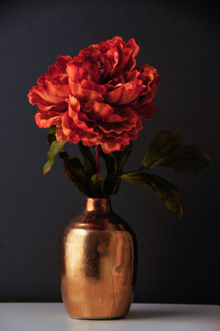Red Flowers In Gold Vase