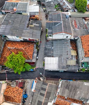 Drone shot showcasing rooftops and streets of a Jakarta neighborhood.