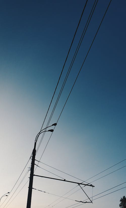 An Electric Wires and Post Under the Blue Sky