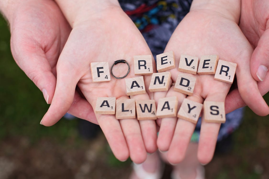 Person Holding Name Letter Blocks