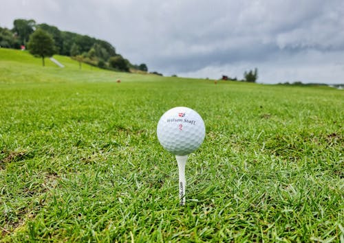 Free Golf Ball on Stand in Grass Stock Photo