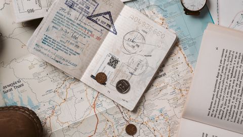 Explore wanderlust with flatlay of passport, map, and travel essentials.