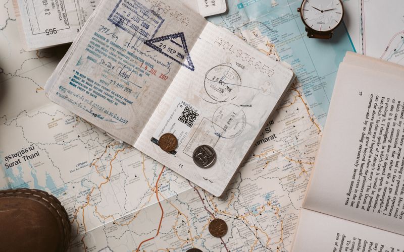 Passport, map and travel essentials laid out on a table