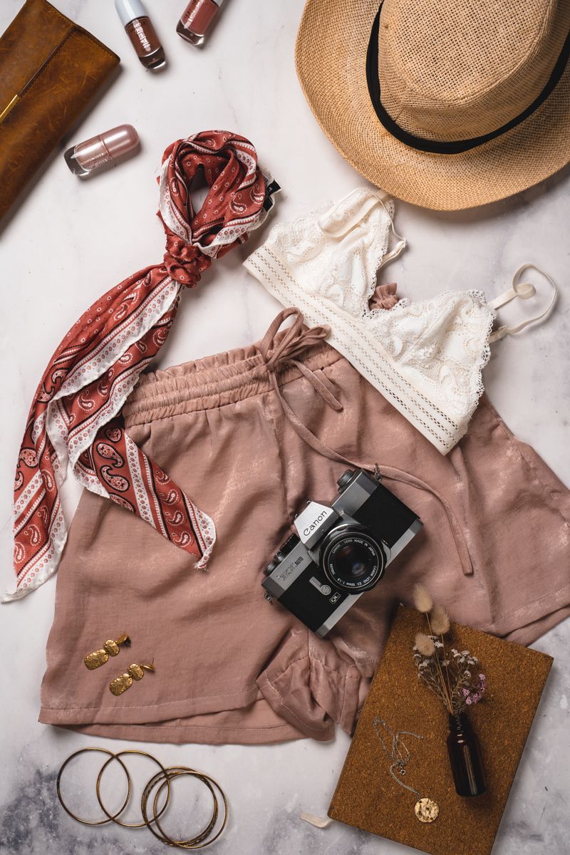 Flat lay of clothing, shoes, and fashion accessories