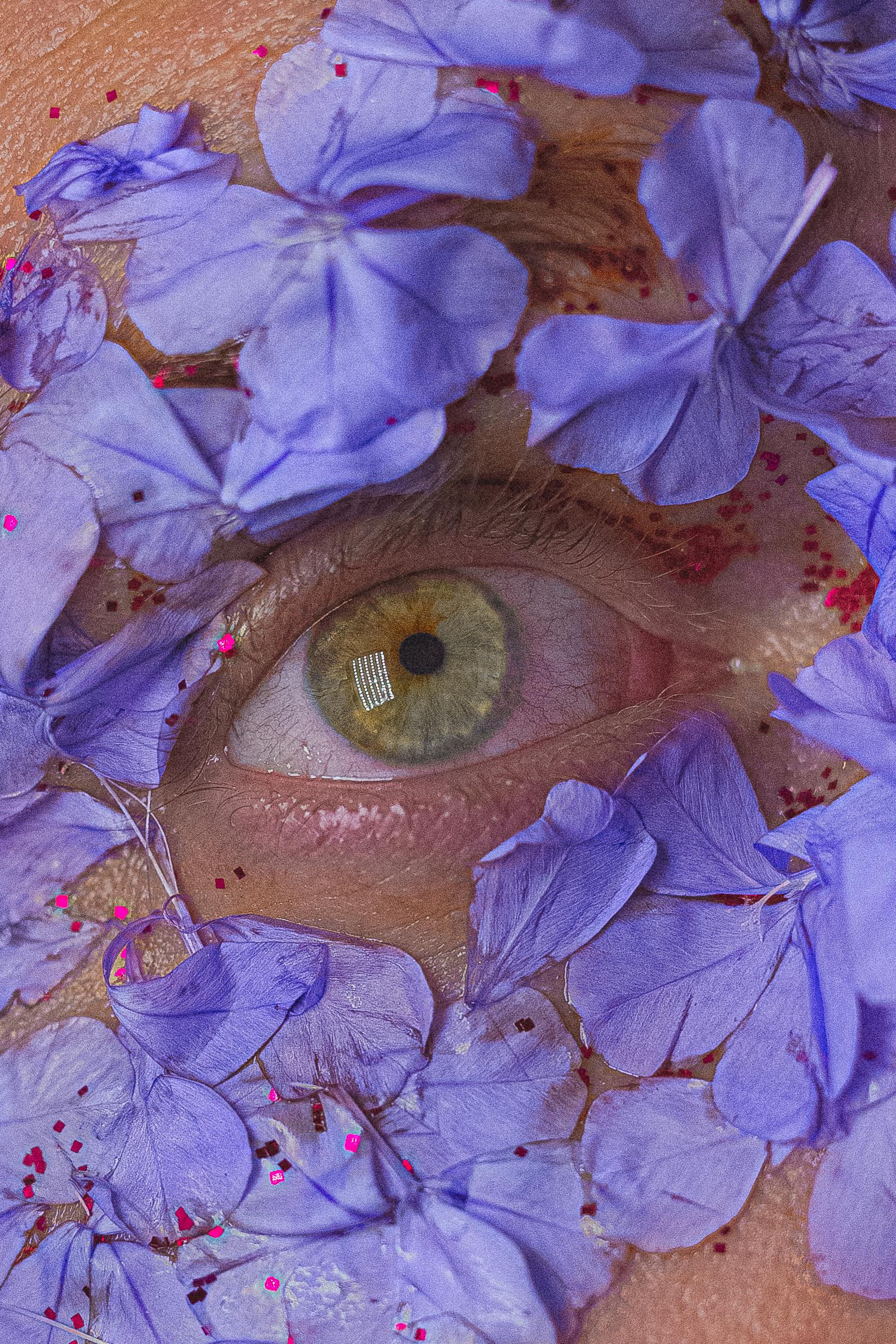 man eye surrounded with blue flowers petals