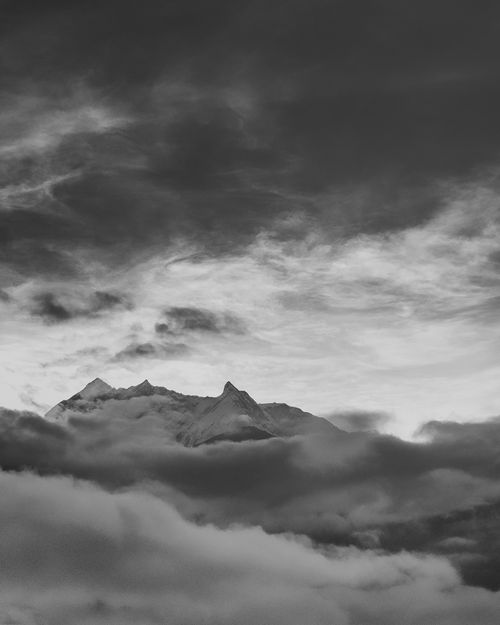 Free Striking black and white image of a mountain peak enveloped by dramatic clouds, Shigatse, Tibet. Stock Photo