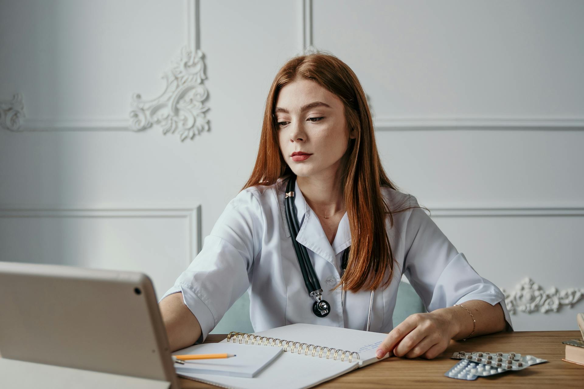 A Medical Doctor Working Behind a Desk