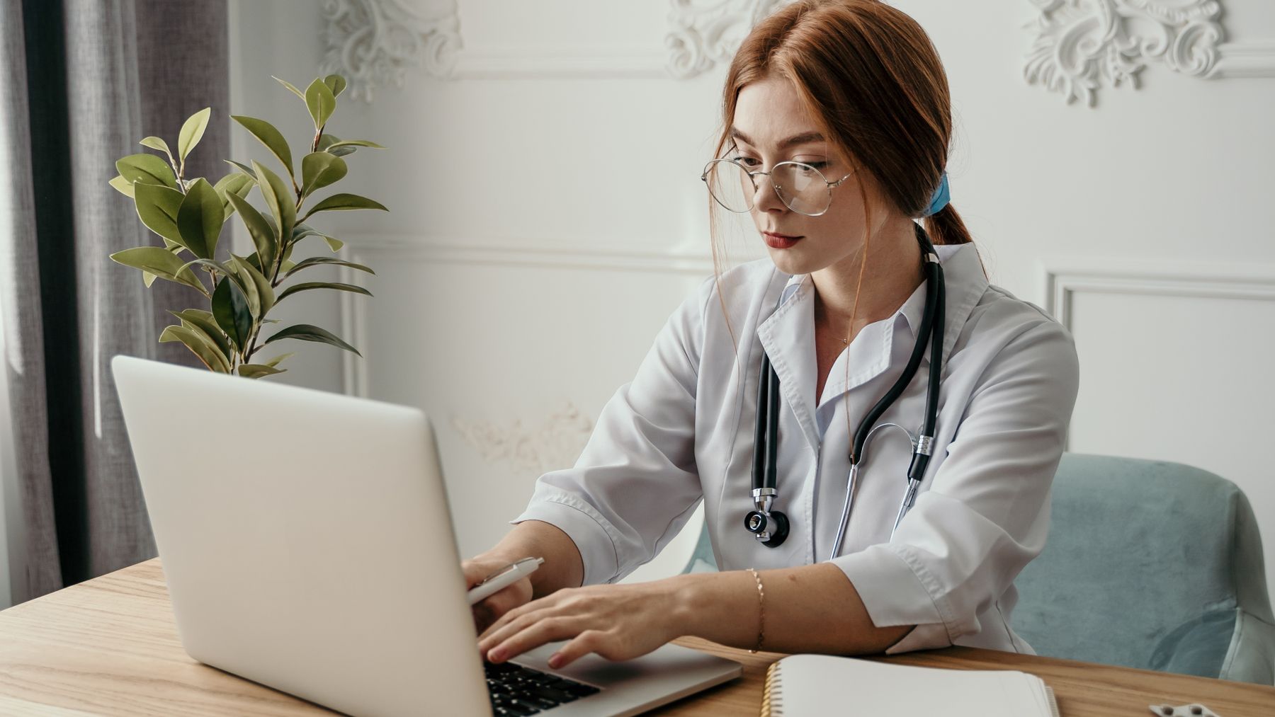 Doctor working on a laptop in a modern medical office
