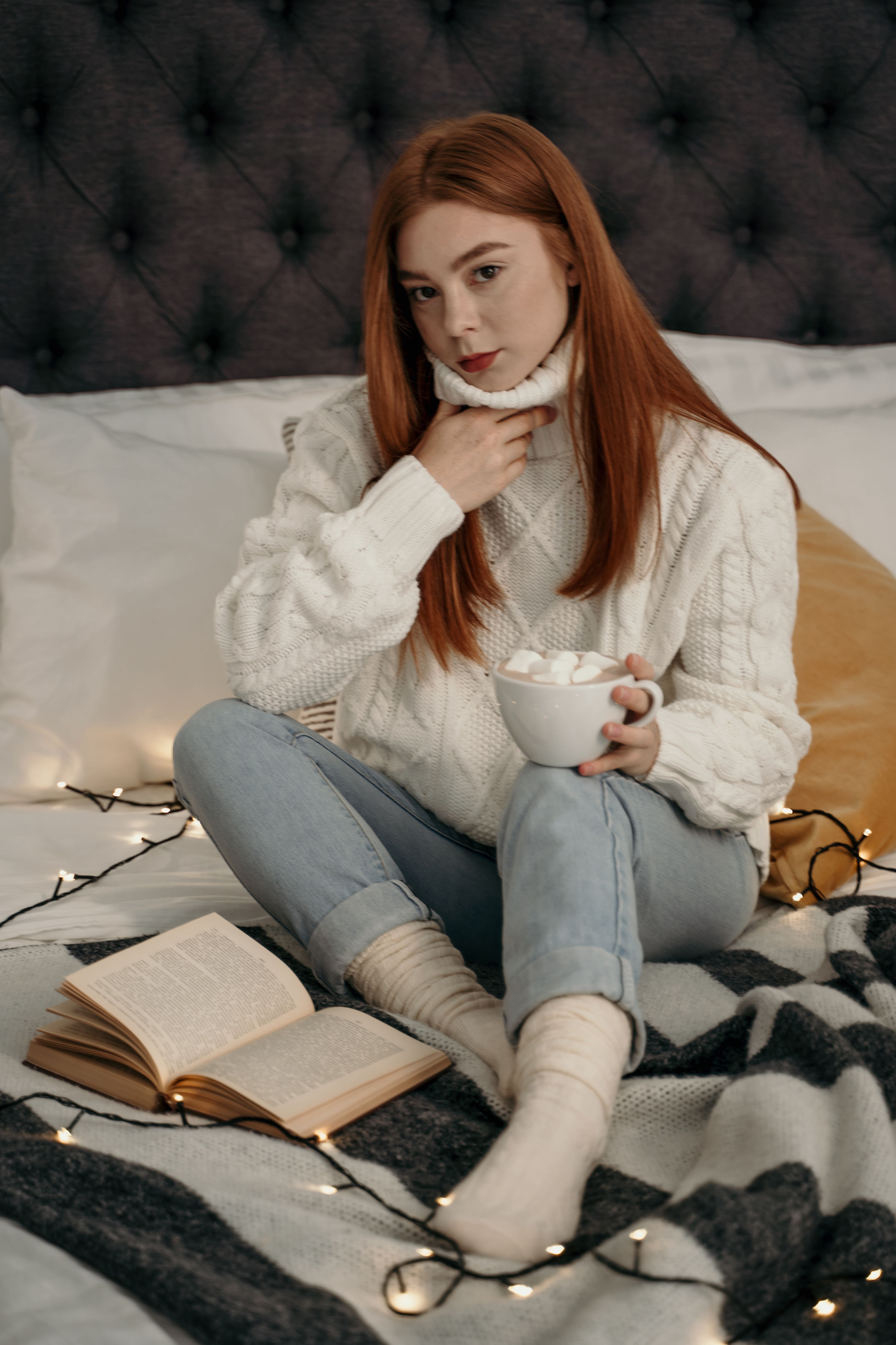 Woman in White Sweater Sitting on Bed · Free Stock Photo