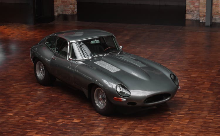 Gray Sports Car Parked On Brown Wooden Floor