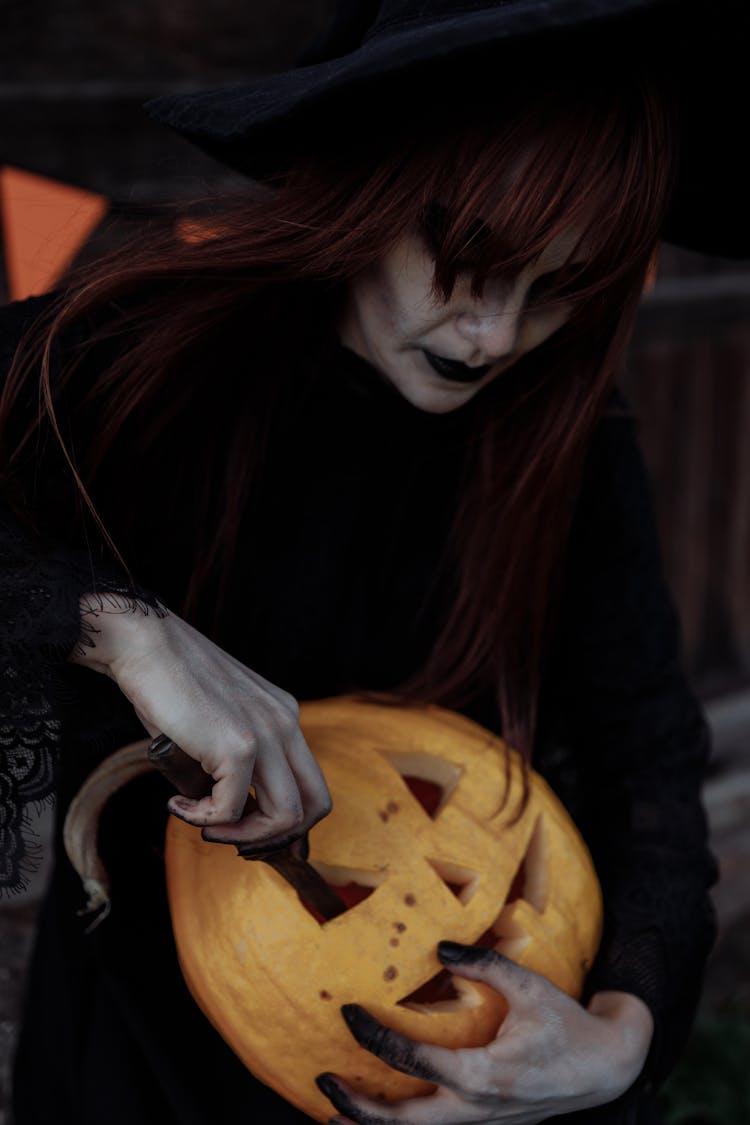 Witch Carving A Pumpkin