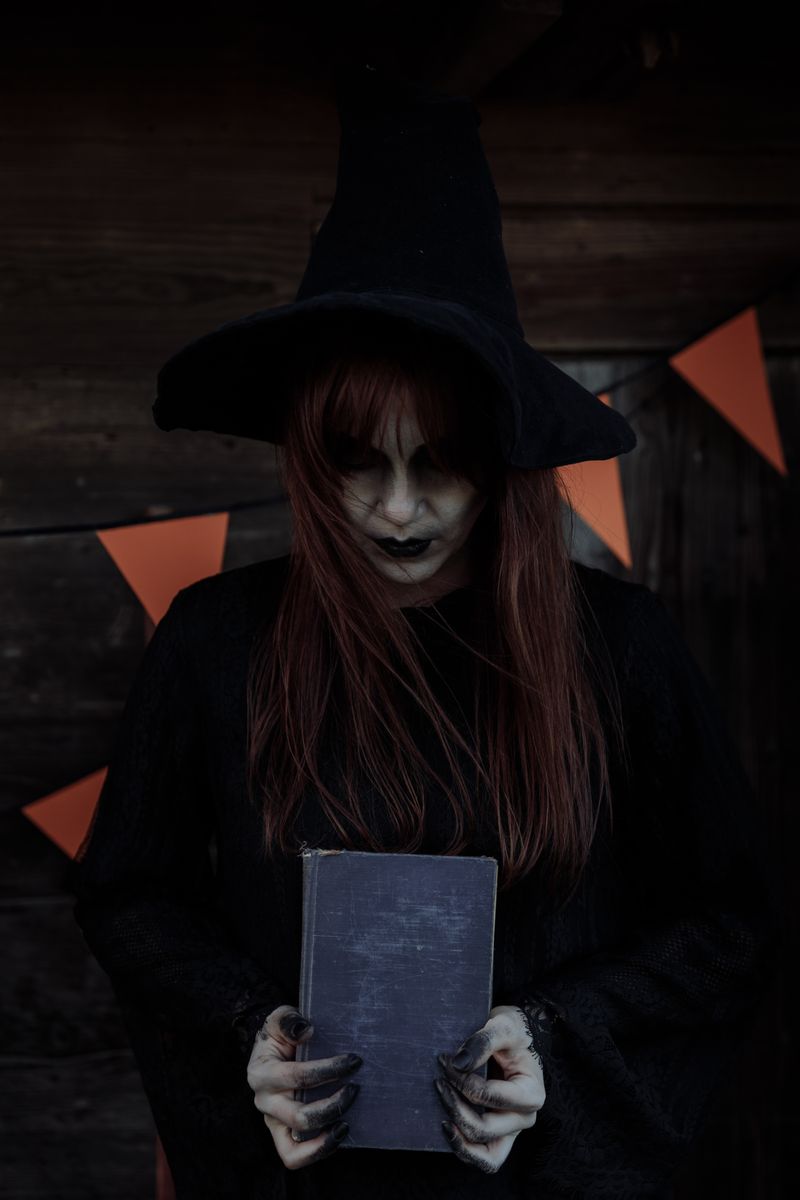 A mysterious witch with long hair and hat holding a spellbook, exuding a spooky Halloween atmosphere.